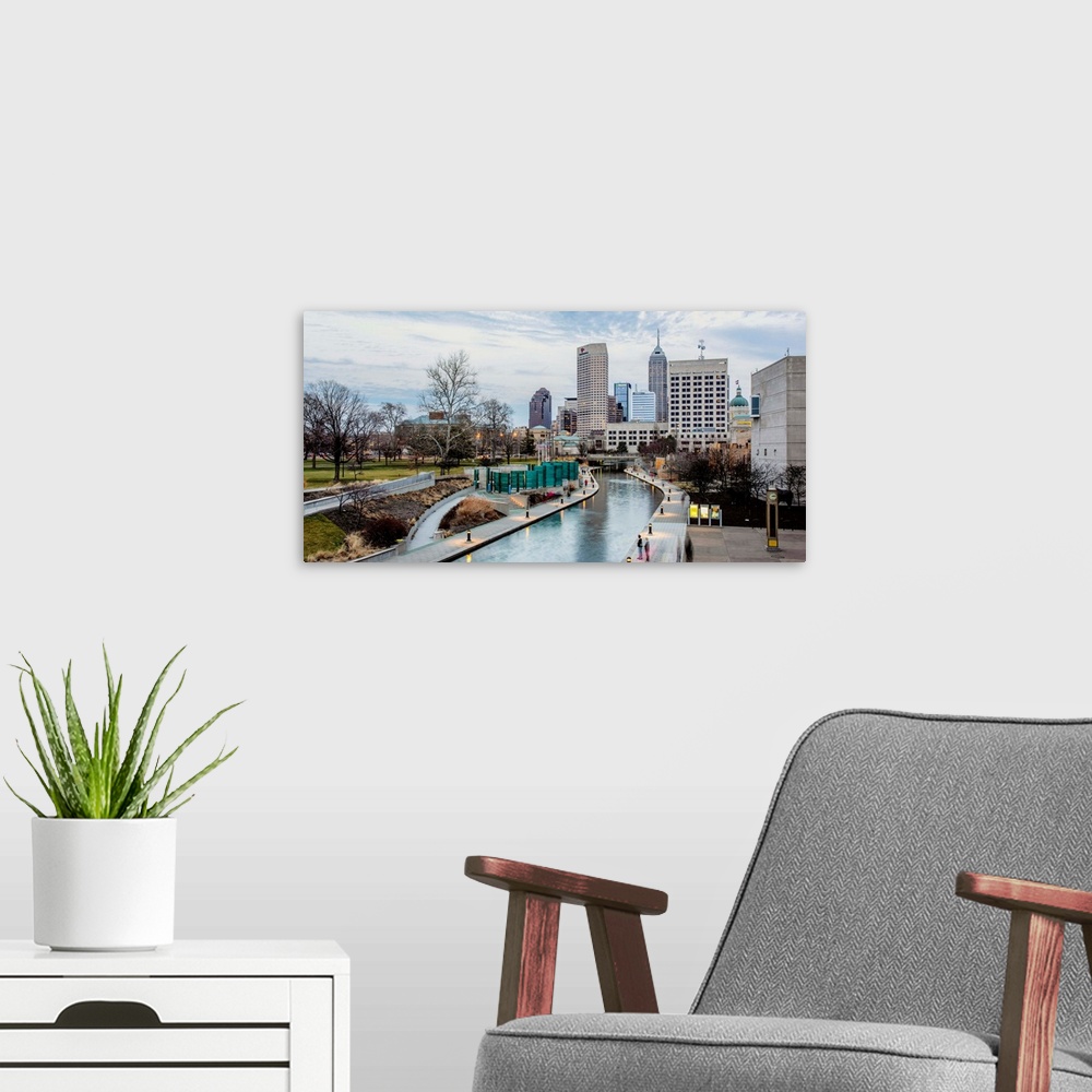 A modern room featuring Photo of the Indianapolis city skyline reflecting onto the Indiana Central Canal.