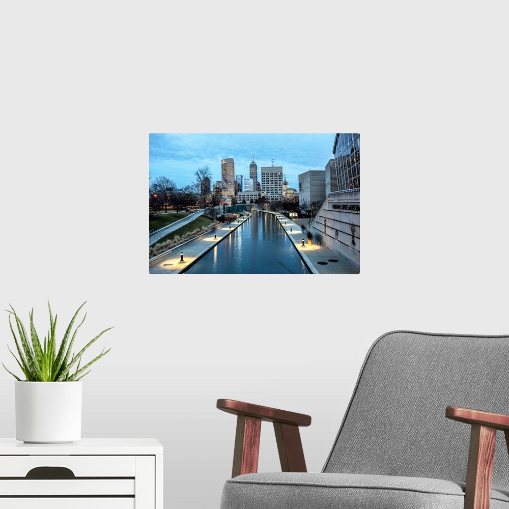 A modern room featuring Photo of the Indianapolis city skyline reflecting onto the Indiana Central Canal.