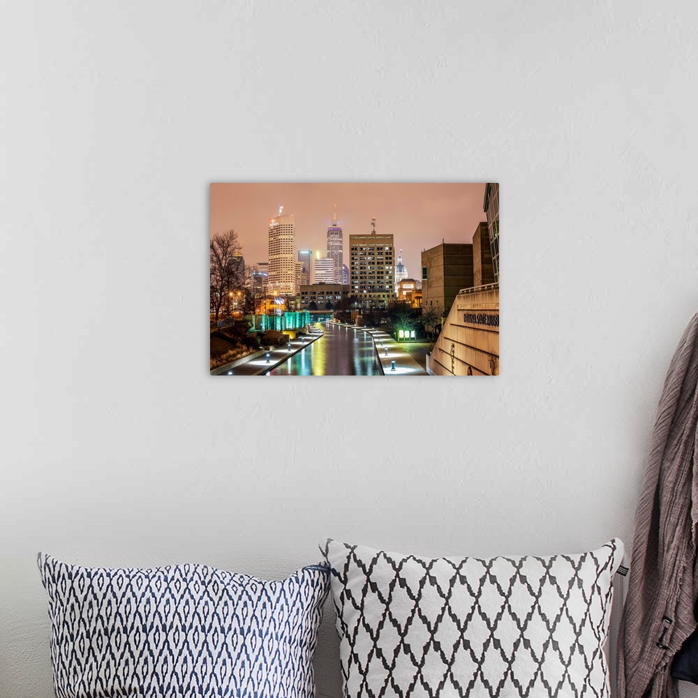 A bohemian room featuring Photo of the Indianapolis city skyline at night reflecting onto the Indiana Central Canal.