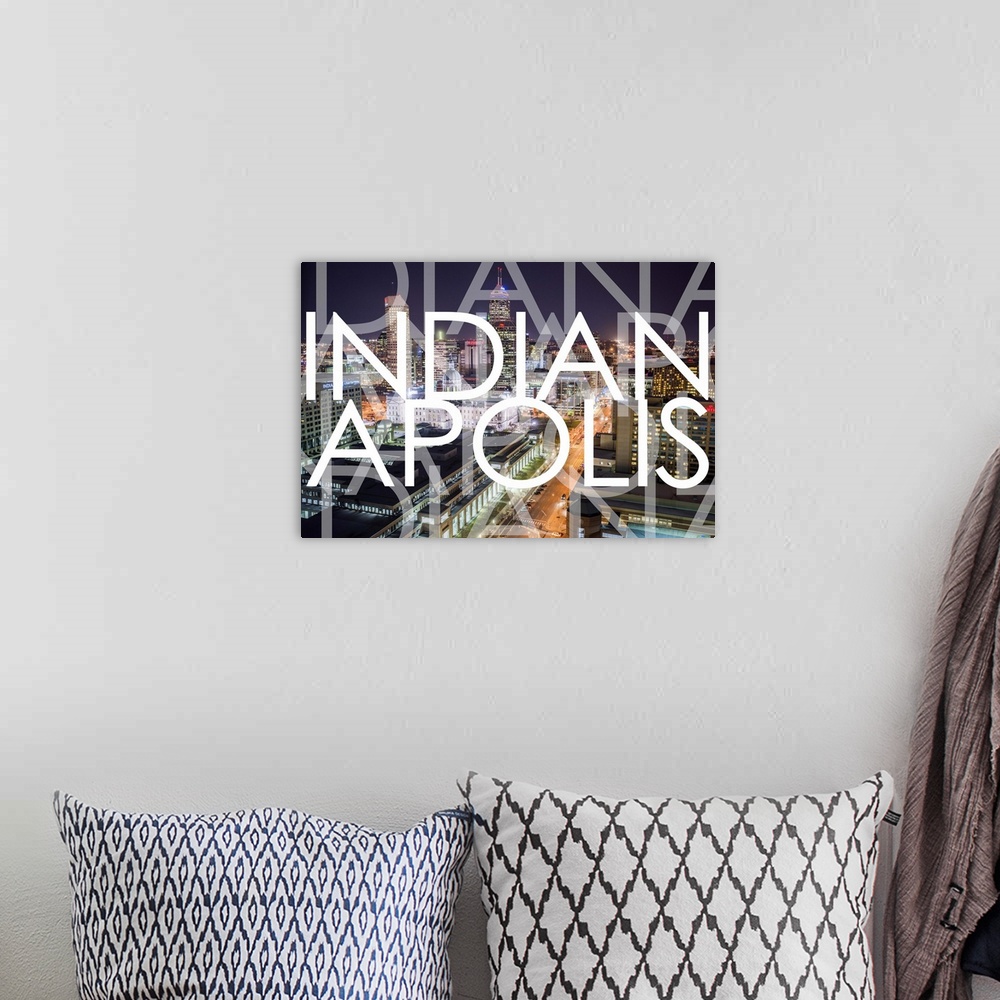 A bohemian room featuring Multi-exposure typography art against a photograph of the Indianapolis city skyline at night.