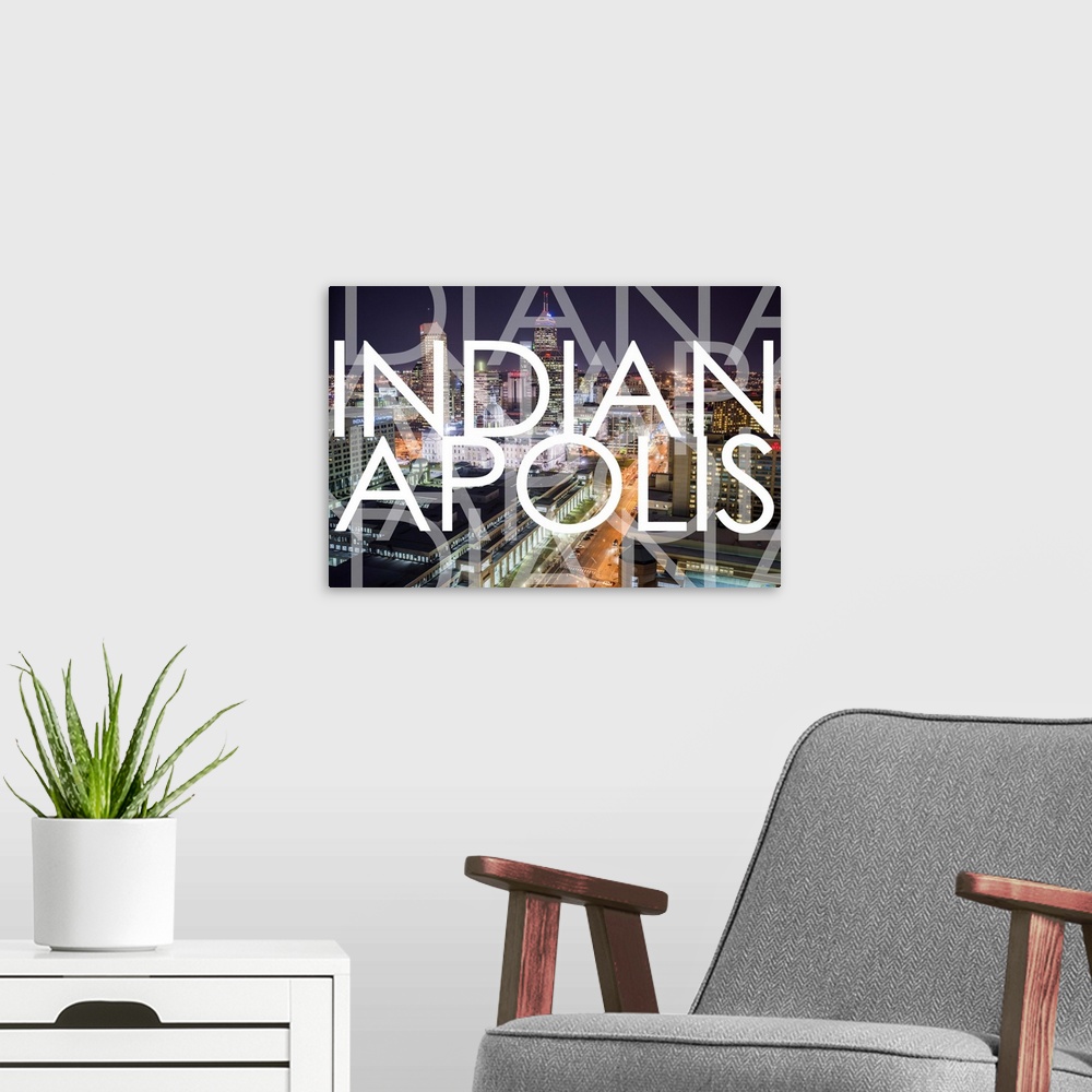 A modern room featuring Multi-exposure typography art against a photograph of the Indianapolis city skyline at night.