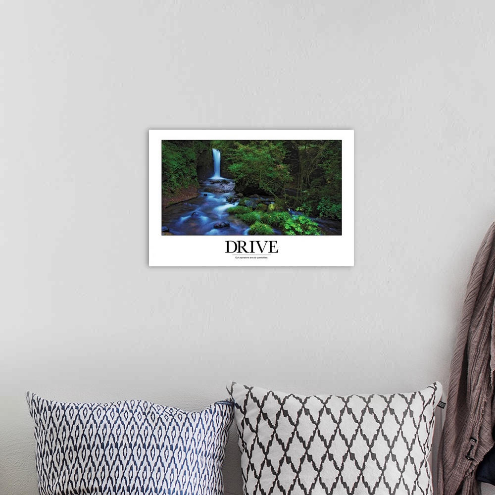 A bohemian room featuring A simple poster with a message of inspiration shows a waterfall and stream in a North American fo...