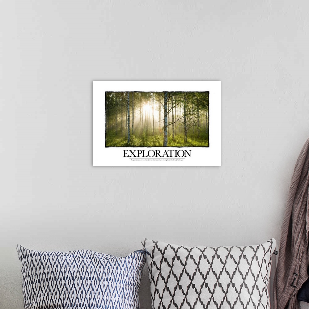 A bohemian room featuring Big canvas print of a forest with a blinding sun shining through and text at the bottom.