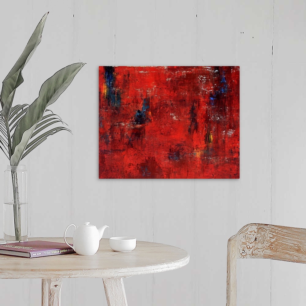 A farmhouse room featuring Abstract painting featuring shades of red and maroon with swipes of blue and yellow.