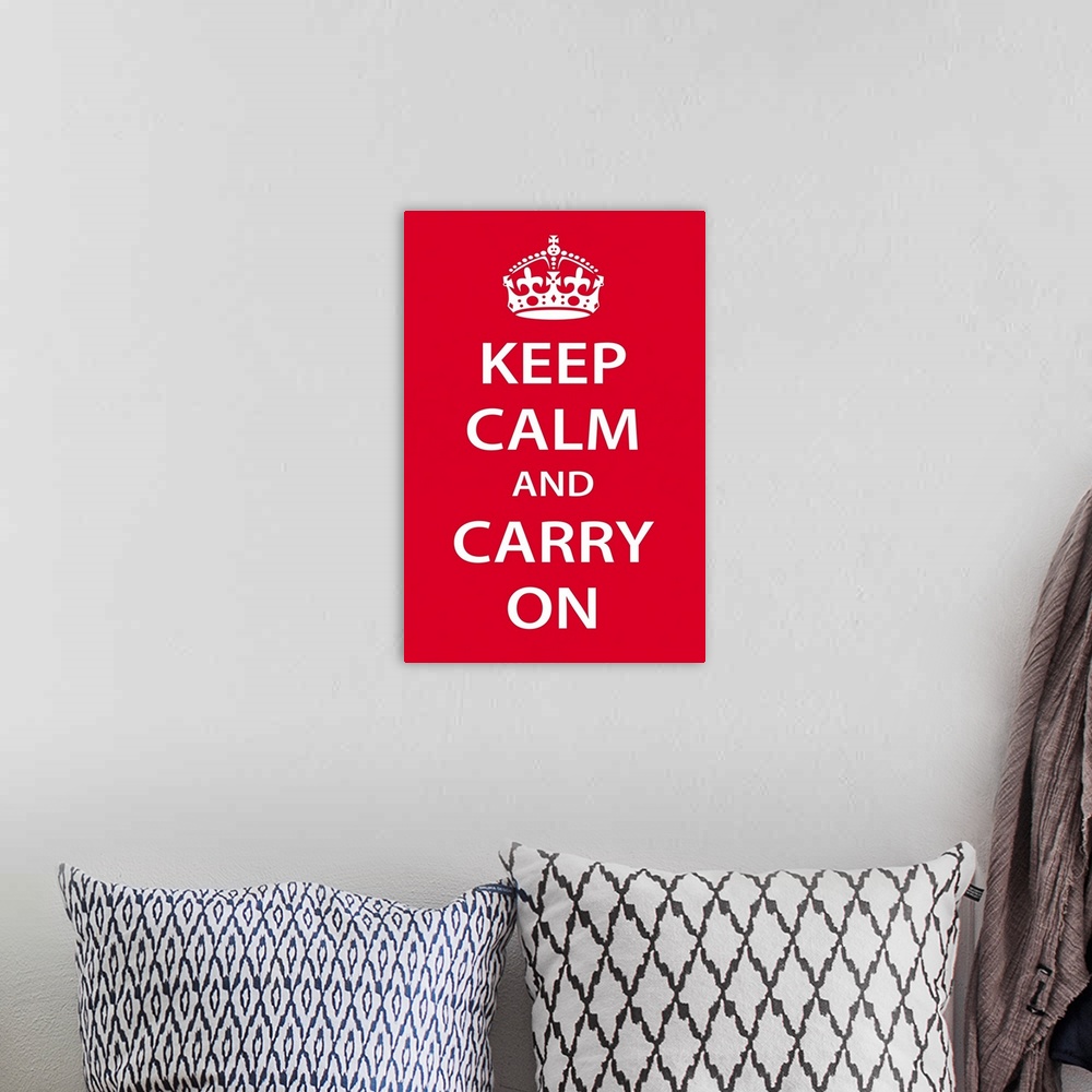 A bohemian room featuring A large vertical print with a red background and the text "Keep Calm and Carry On" in bold white ...
