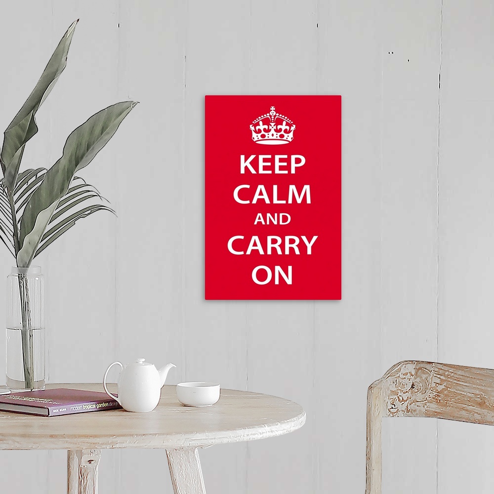A farmhouse room featuring A large vertical print with a red background and the text "Keep Calm and Carry On" in bold white ...