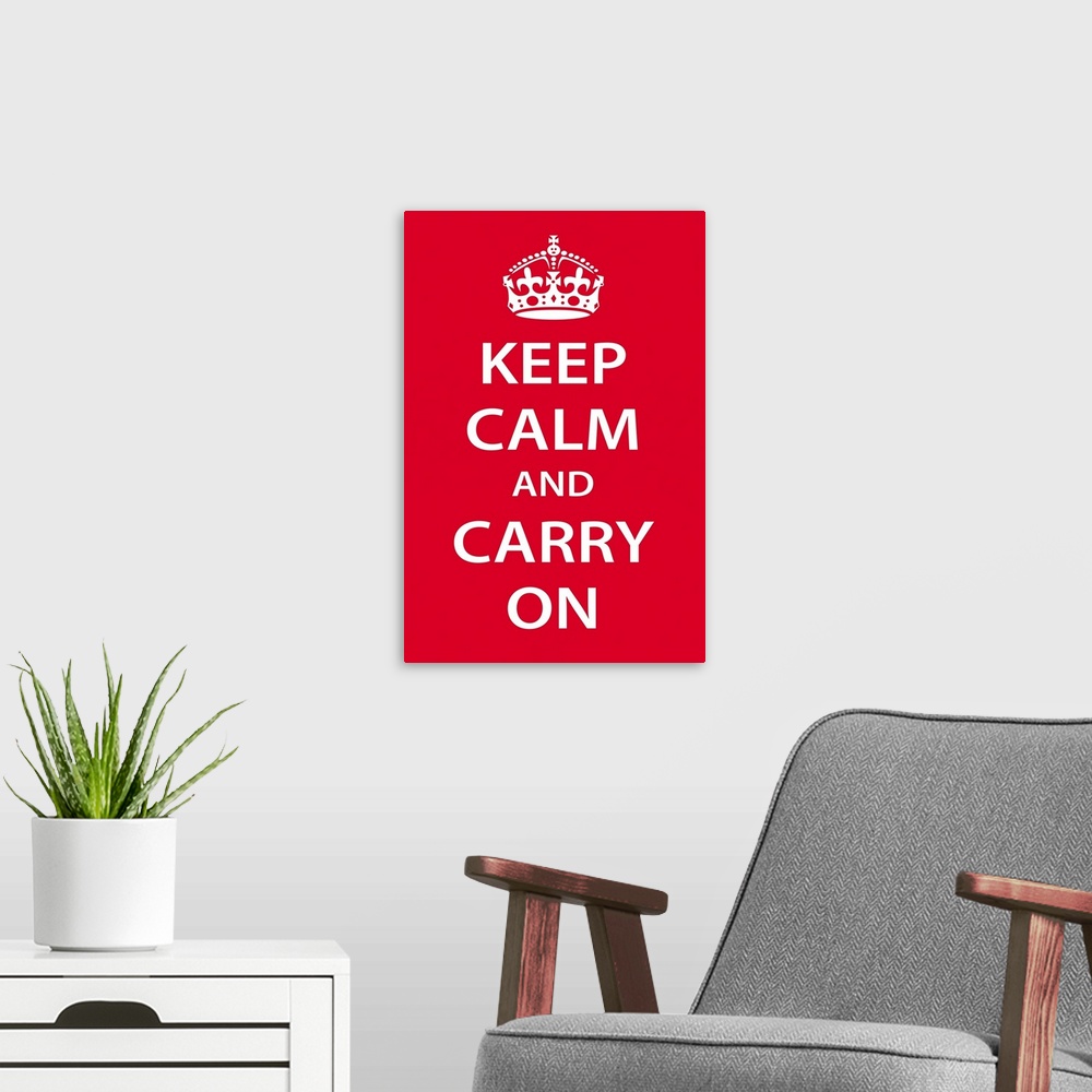 A modern room featuring A large vertical print with a red background and the text "Keep Calm and Carry On" in bold white ...