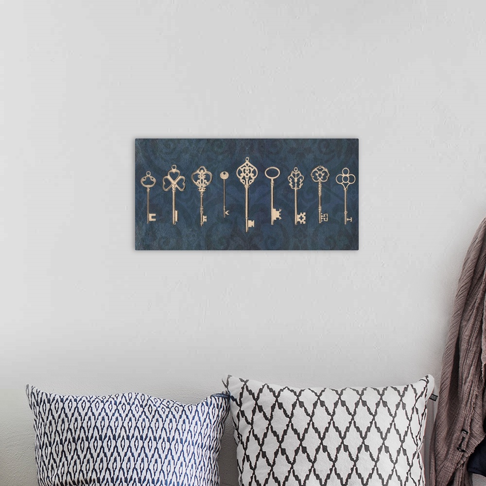 A bohemian room featuring An assortment of vintage keys with ornate designs arranged in a row on a navy blue background.