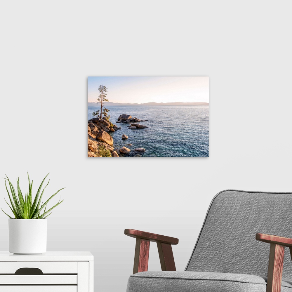 A modern room featuring View of Lake Tahoe's rocky shore with mountain landscape in the background in California and Nevada.