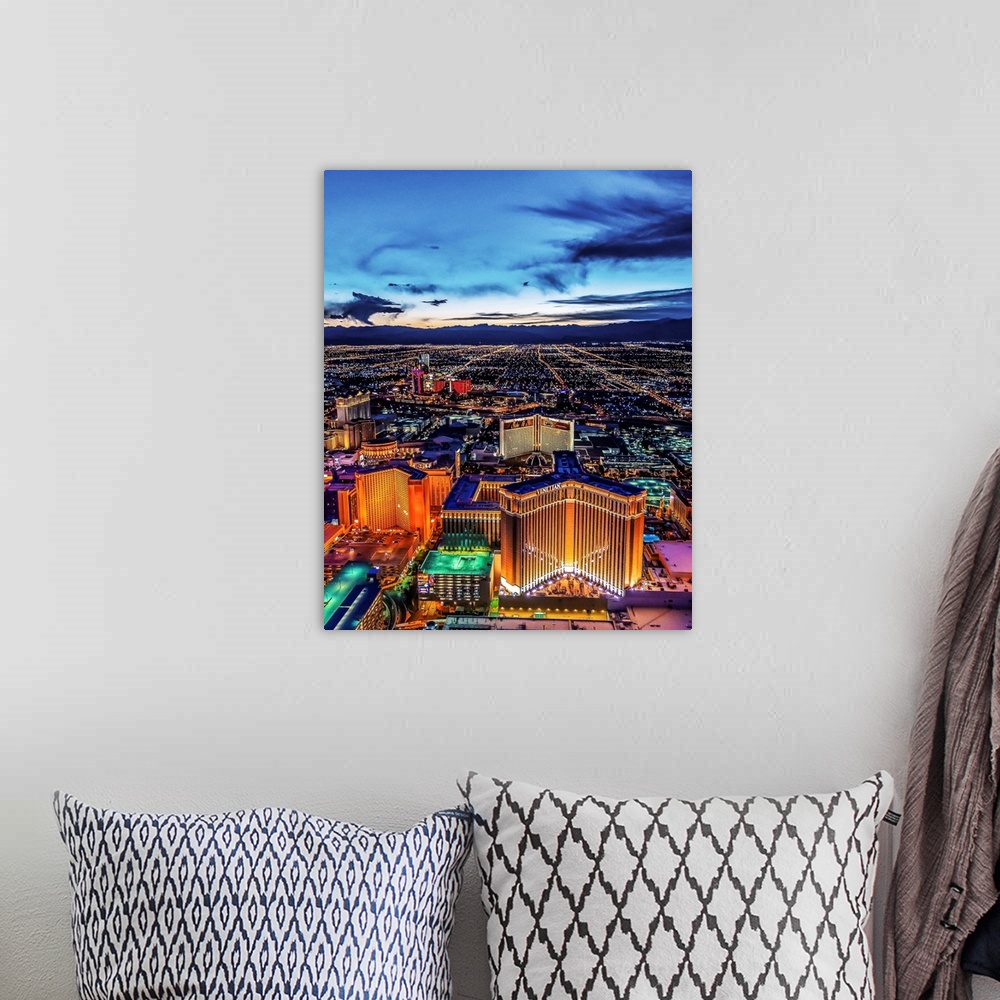 A bohemian room featuring Aerial view of the Las Vegas Strip illuminated in the early evening with cloudy skies.