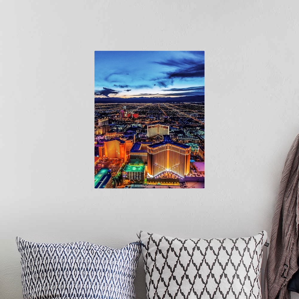 A bohemian room featuring Aerial view of the Las Vegas Strip illuminated in the early evening with cloudy skies.