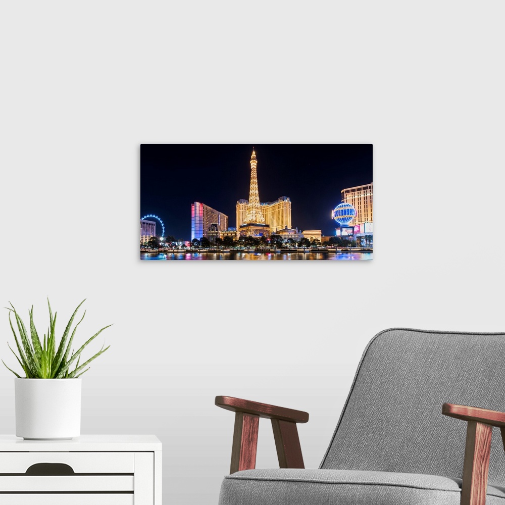 A modern room featuring Panoramic photograph of the Las Vegas Strip lit up at night highlighting the Eiffel Tower Restaur...