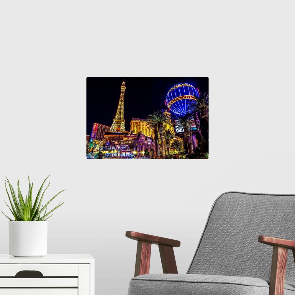 A modern room featuring Evening photograph of the Las Vegas strip with the Eiffel Tower and hot air balloon.