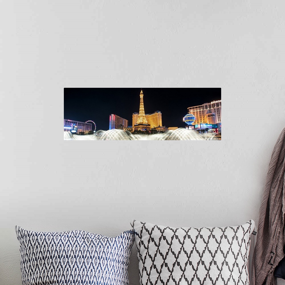 A bohemian room featuring Panoramic photograph of the Las Vegas strip at night with the Bellagio Fountain water show in the...