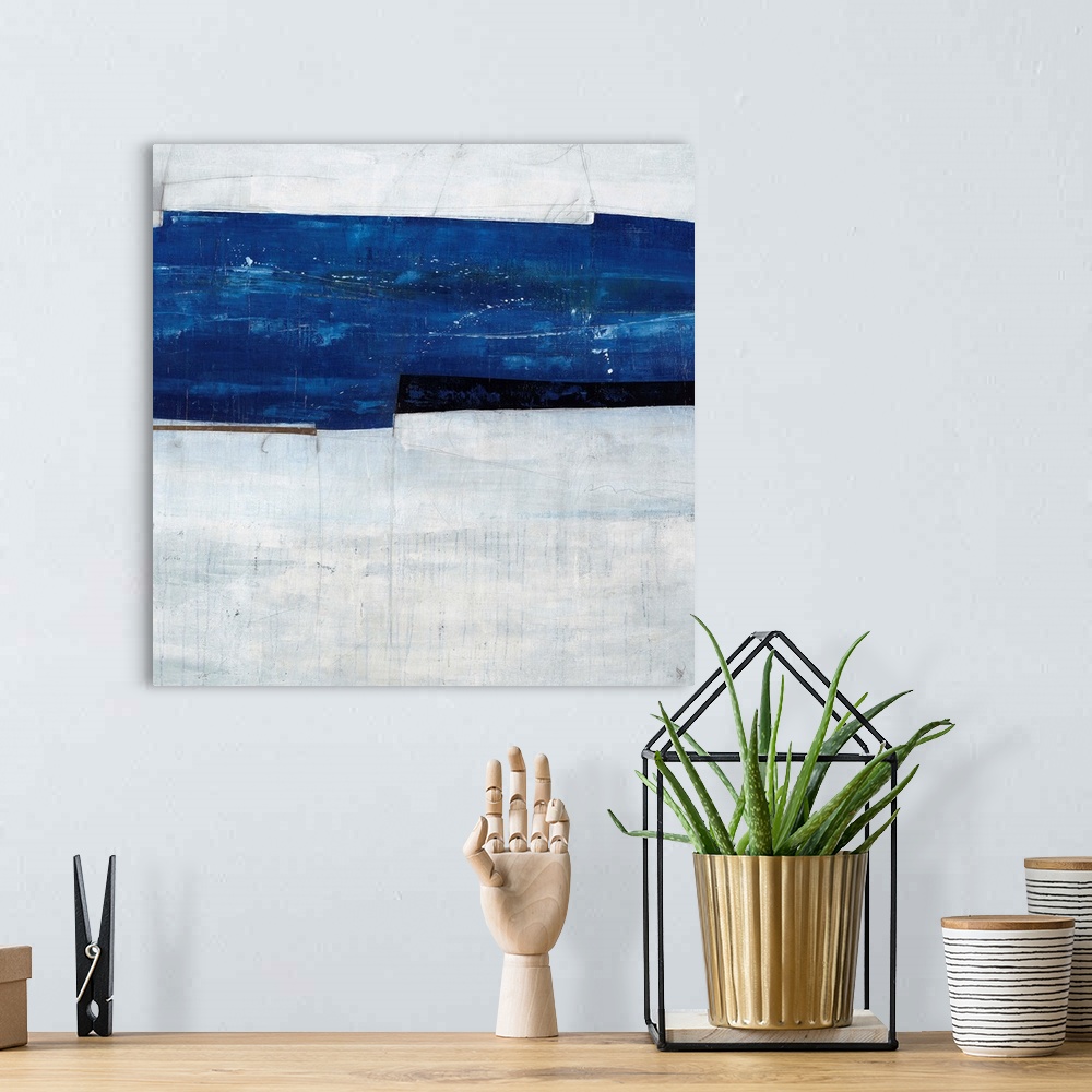 A bohemian room featuring Abstract painting of a navy blue strip over a cool, gray-blue background.