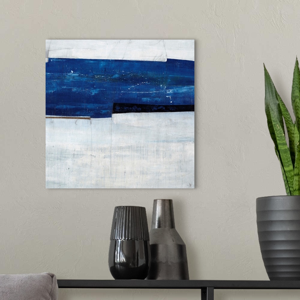 A modern room featuring Abstract painting of a navy blue strip over a cool, gray-blue background.