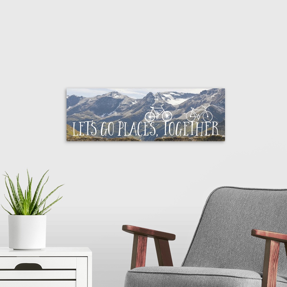 A modern room featuring Handwritten sentiment with two small bicycles over an image of a snowy mountain range.