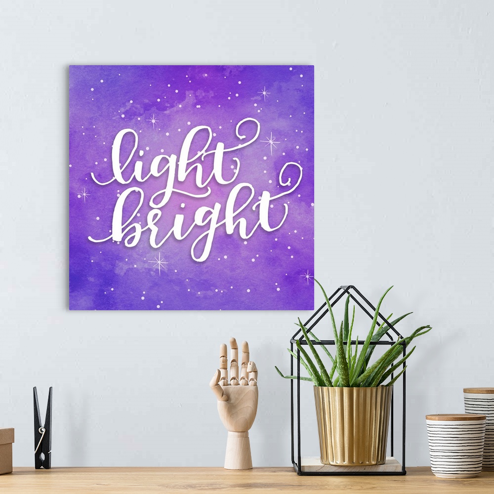 A bohemian room featuring Handlettered text reading "Light Bright" on a purple starry background.