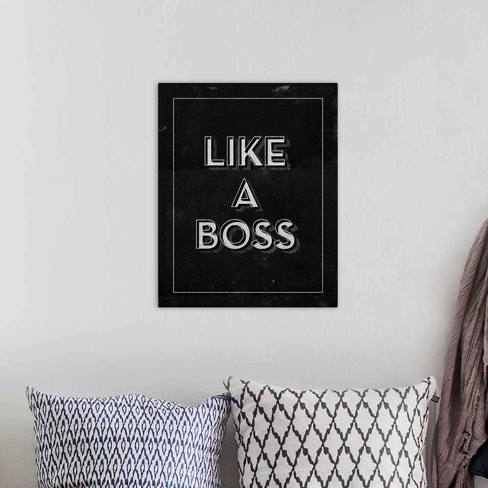 A bohemian room featuring Slightly distressed artwork with the words, "Like A Boss" in black and white.