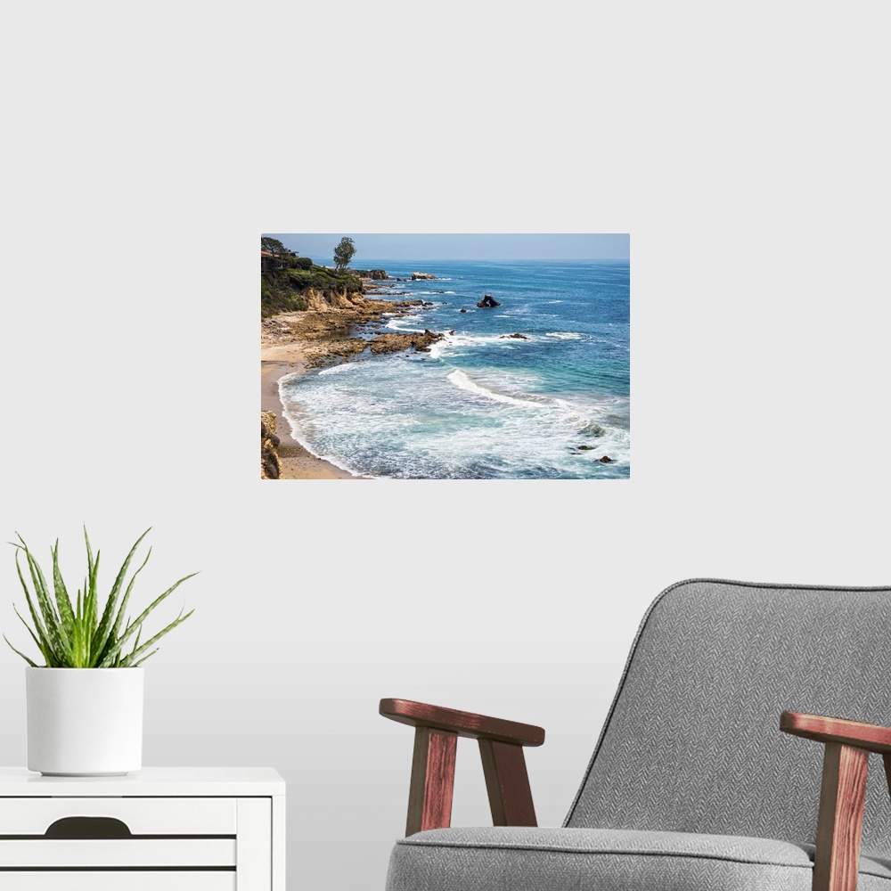A modern room featuring Little Corona del Mar beach is relatively small, flanked on both sides with rocky reefs.
