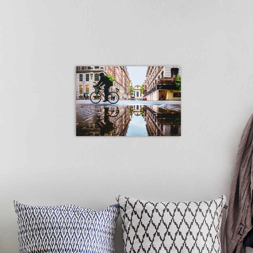 A bohemian room featuring Photograph of a biker reflecting into a puddle in London, England.