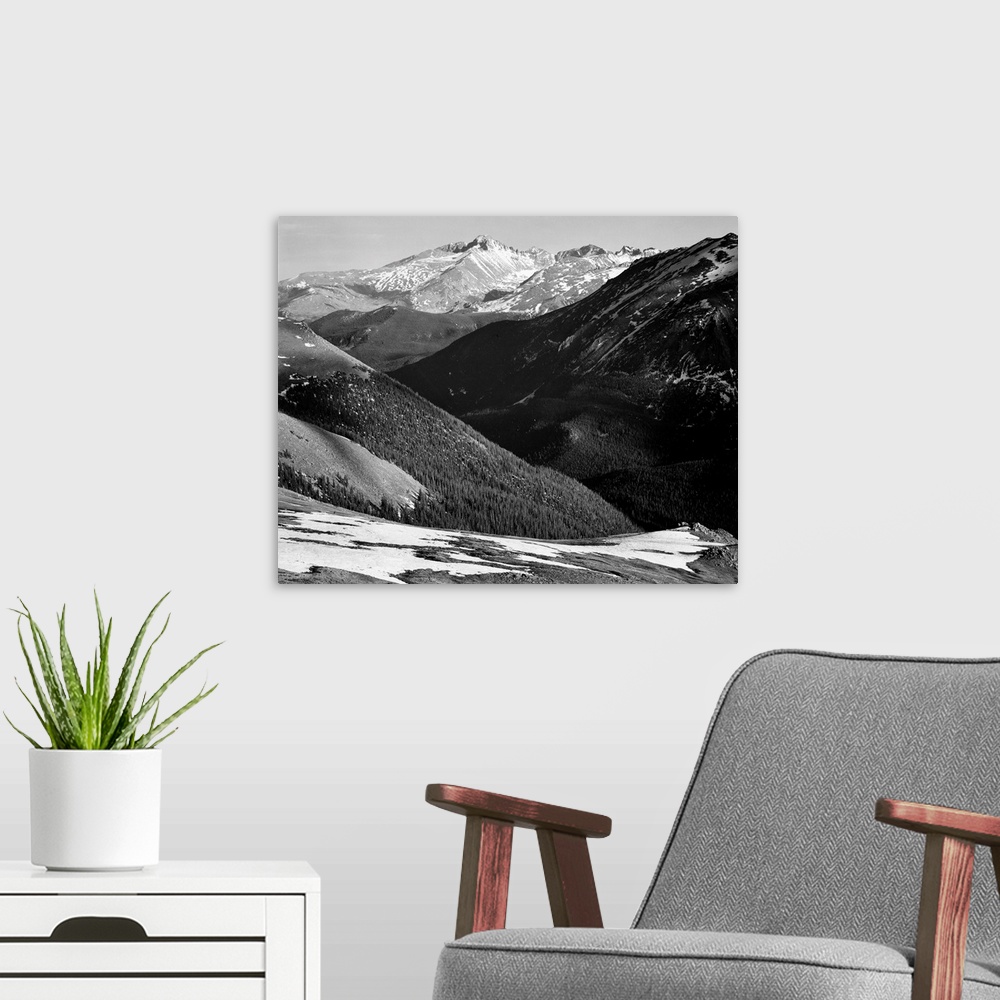 A modern room featuring Long's Peak, Rocky Mountain National Park, close in panorama, dark shadowed hills in foreground, ...