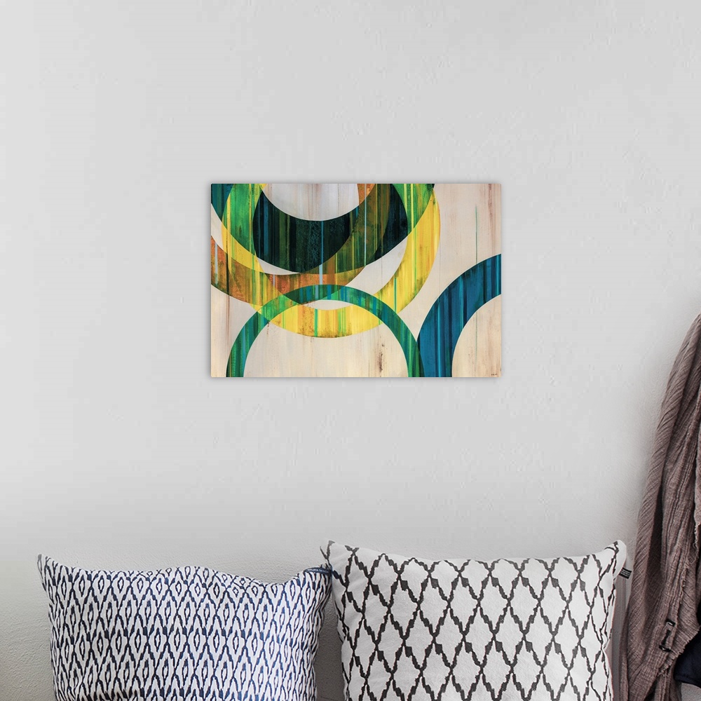 A bohemian room featuring Modern abstract art of circular rings painting in shades of blue, green, yellow, and orange over ...