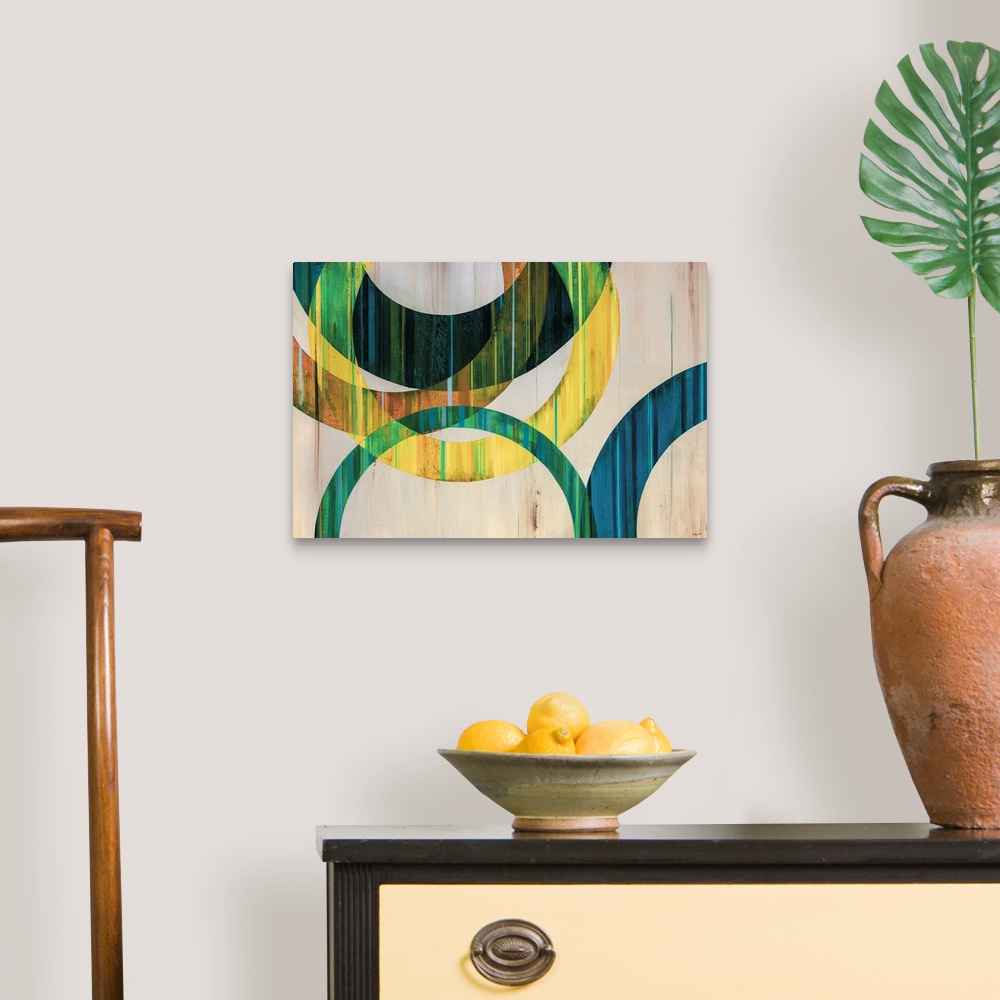 A traditional room featuring Modern abstract art of circular rings painting in shades of blue, green, yellow, and orange over ...
