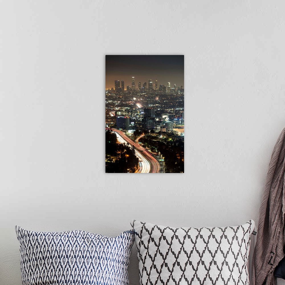 A bohemian room featuring Aerial view photograph of Los Angeles, California with a hazy skyline at night.