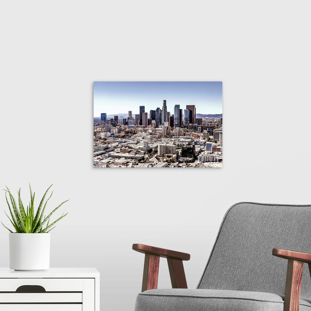 A modern room featuring Skyscrapers and surrounding buildings of the Los Angeles skyline under a blue sky, California.