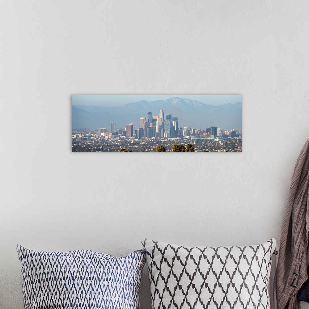 A bohemian room featuring Panoramic photograph of the Los Angeles, California skyline with mountains in the background and ...
