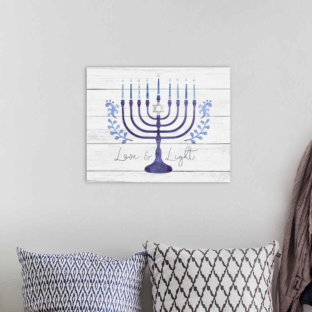 A bohemian room featuring Hanukkah decorative art featuring a blue menorah and the words Love and Light on a distressed bar...