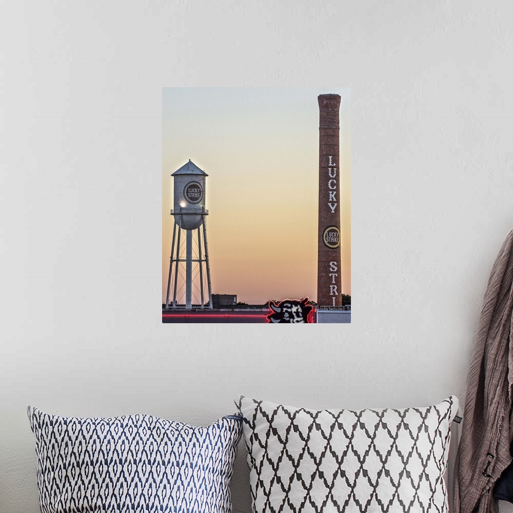 A bohemian room featuring Lucky Strike Water Tower and Smokestack at sunset, over the neon Bull sign, American Tobacco Hist...