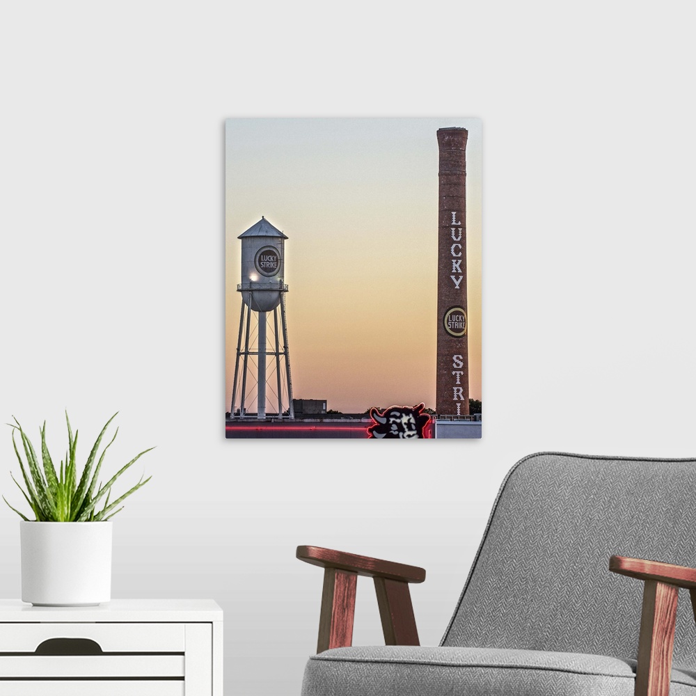 A modern room featuring Lucky Strike Water Tower and Smokestack at sunset, over the neon Bull sign, American Tobacco Hist...