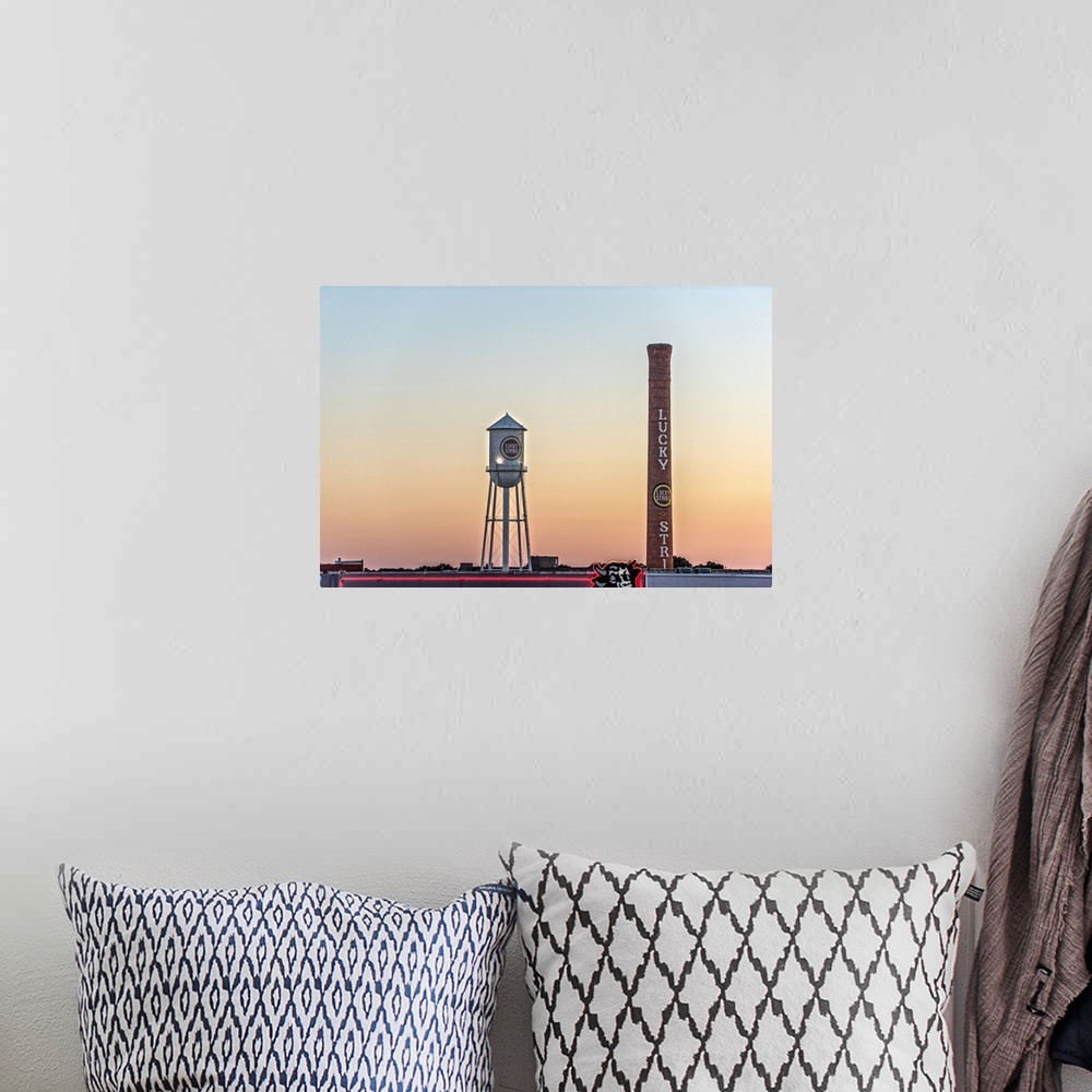 A bohemian room featuring Lucky Strike Water Tower and Smokestack at sunset, over the neon Bull sign, American Tobacco Hist...
