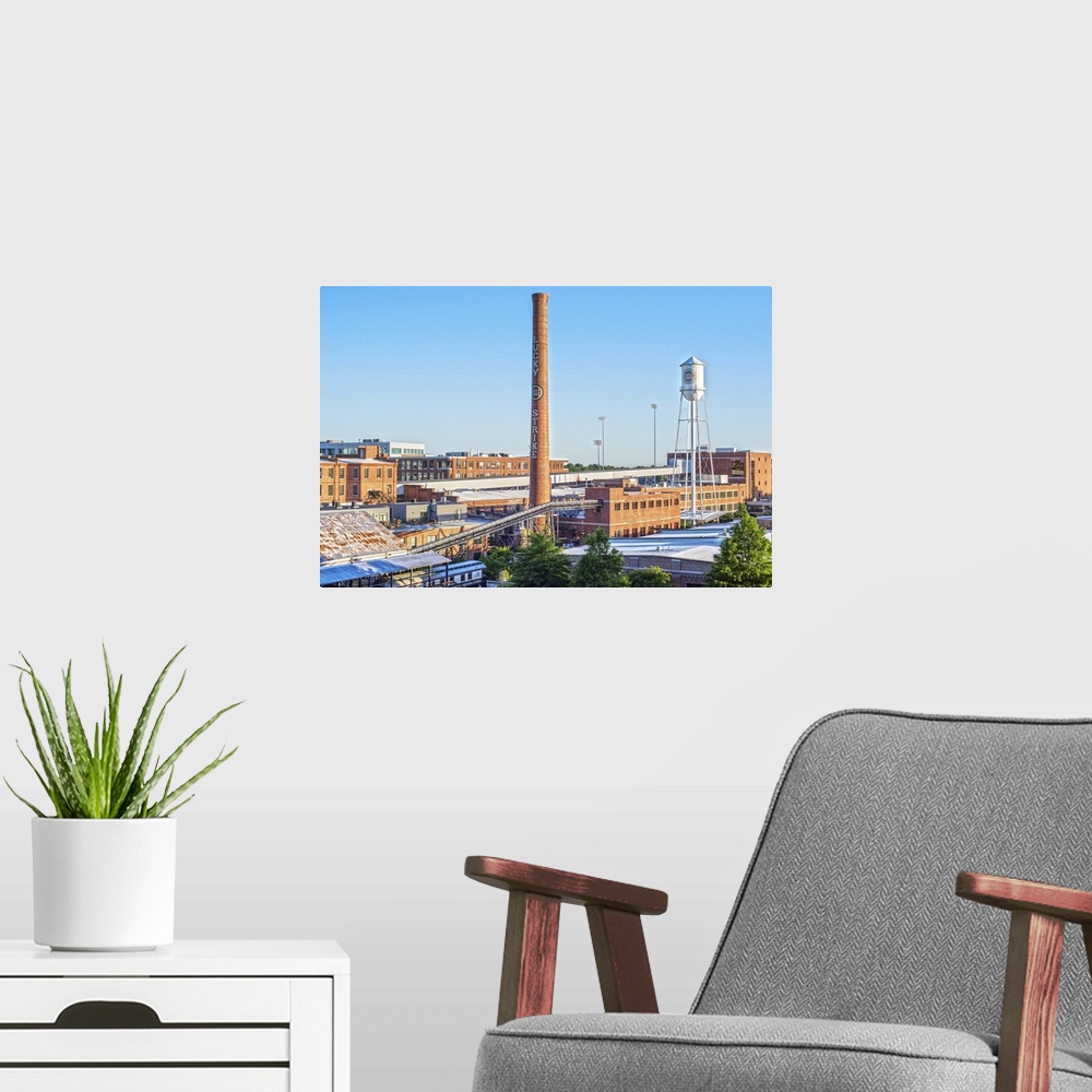 A modern room featuring Lucky Strike Water Tower and Smokestack over the brick factory building, American Tobacco Histori...