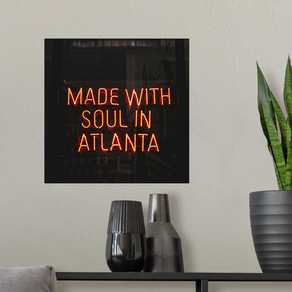 A modern room featuring Made With Soul In Atlanta, a yellow neon sign in the window of Switchyards Downtown Club in Atlan...
