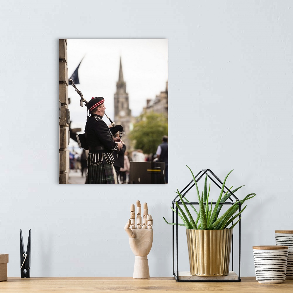 A bohemian room featuring Photograph of a man playing bagpipes in the city of Edinburgh, Scotland, UK.