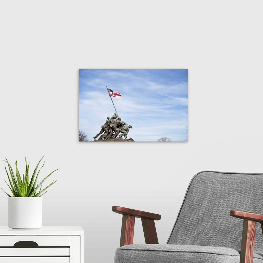 A modern room featuring The Iwo Jima Memorial Statue against a blue sky in Washington, DC.