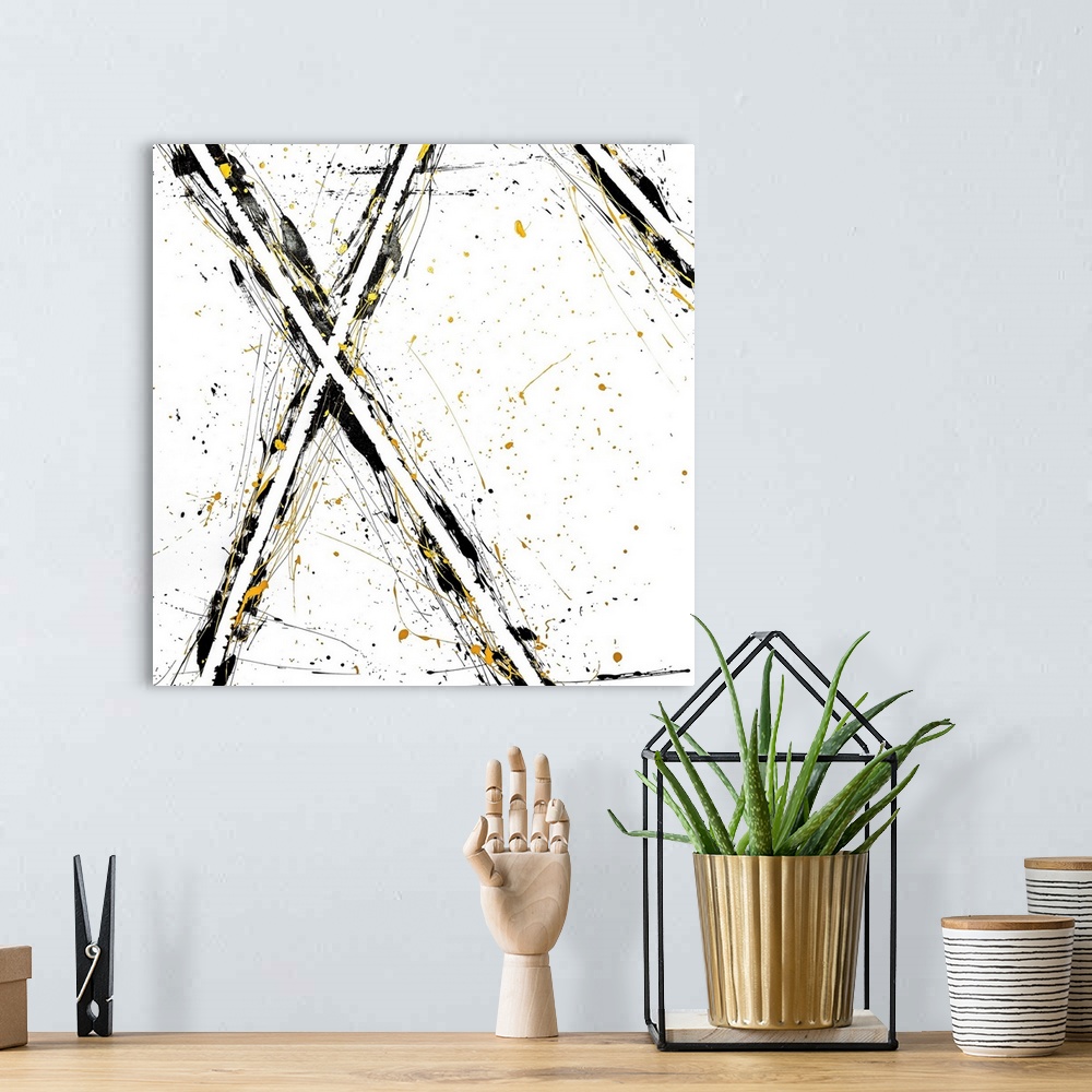 A bohemian room featuring Abstract contemporary art forming an 'x' shape with black and yellow streaks.