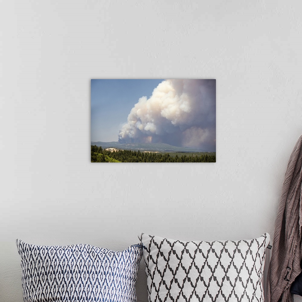 A bohemian room featuring Massive billowing smoke clouds from the Brian Head forest fire in the sky over the Utah landscape.