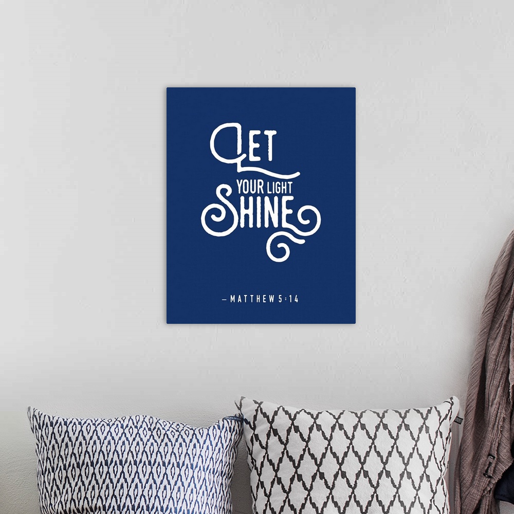 A bohemian room featuring Handlettered Bible verse reading Let your light shine.