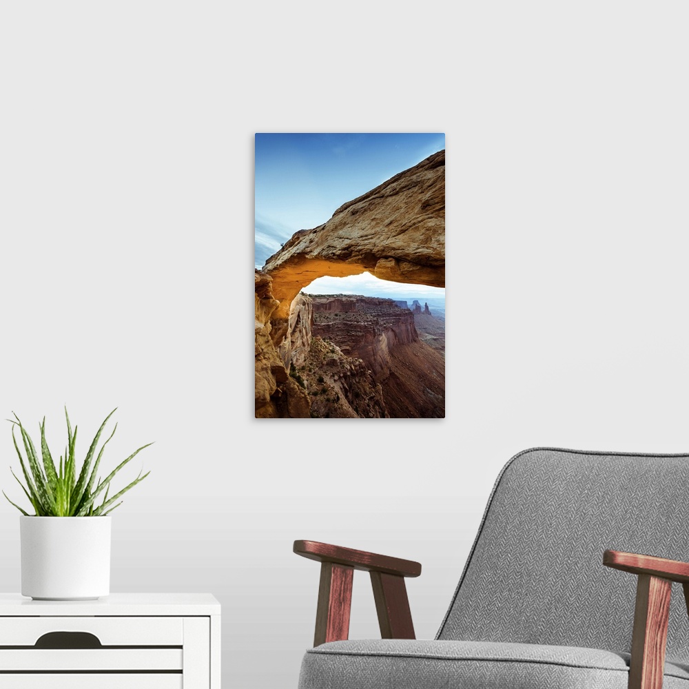 A modern room featuring Photograph of the Mesa Arch with canyons in the background in Arches National Park, Utah.