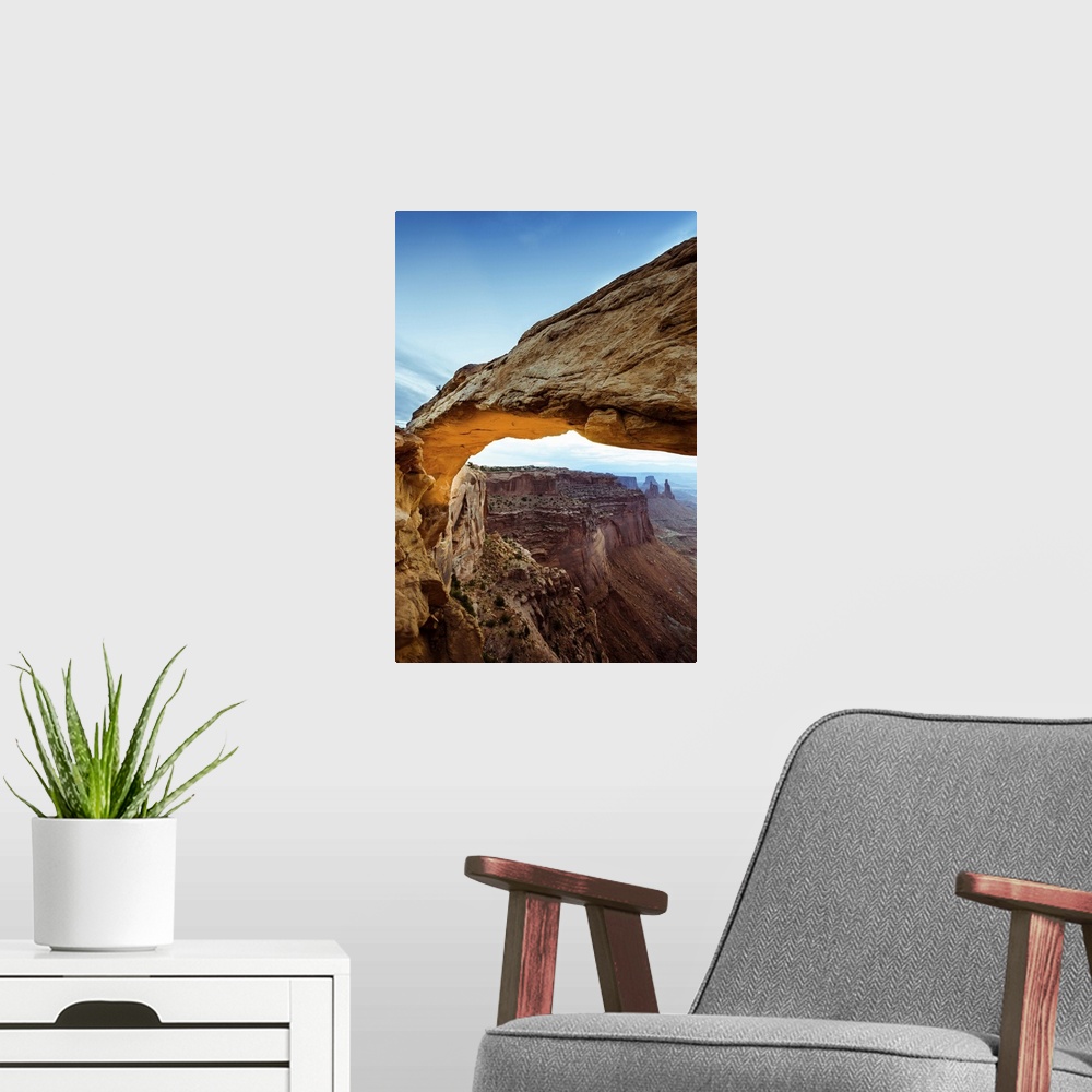 A modern room featuring Photograph of the Mesa Arch with canyons in the background in Arches National Park, Utah.