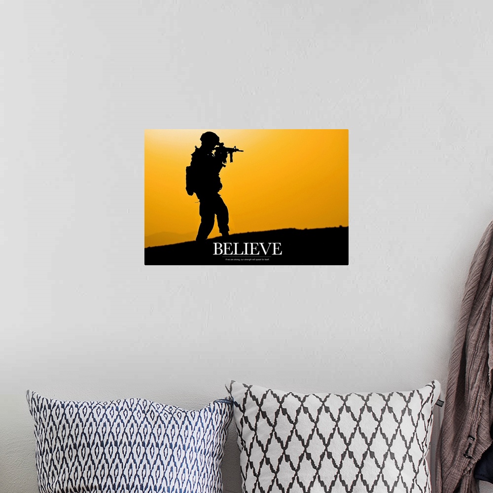 A bohemian room featuring This piece shows a silhouette of a solider holding his gun with the word "Believe" written below ...