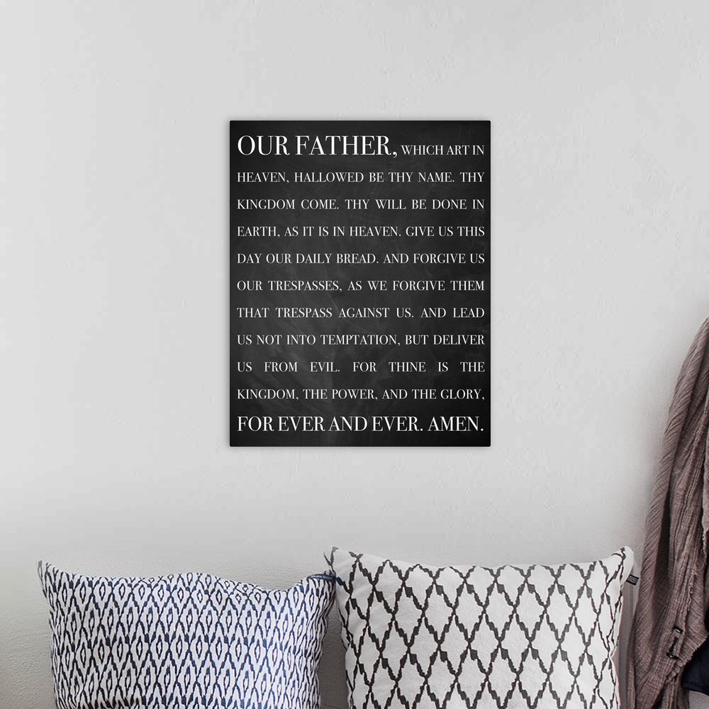 A bohemian room featuring A bold, monochromatic typographical image that displays the words of the Lord's Prayer in white l...