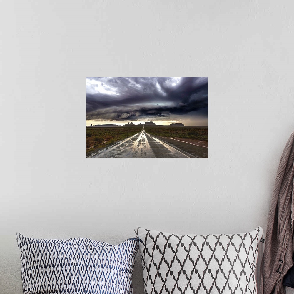 A bohemian room featuring Photograph of Monument Valley with dramatic clouds above taken from a wet road after a storm.