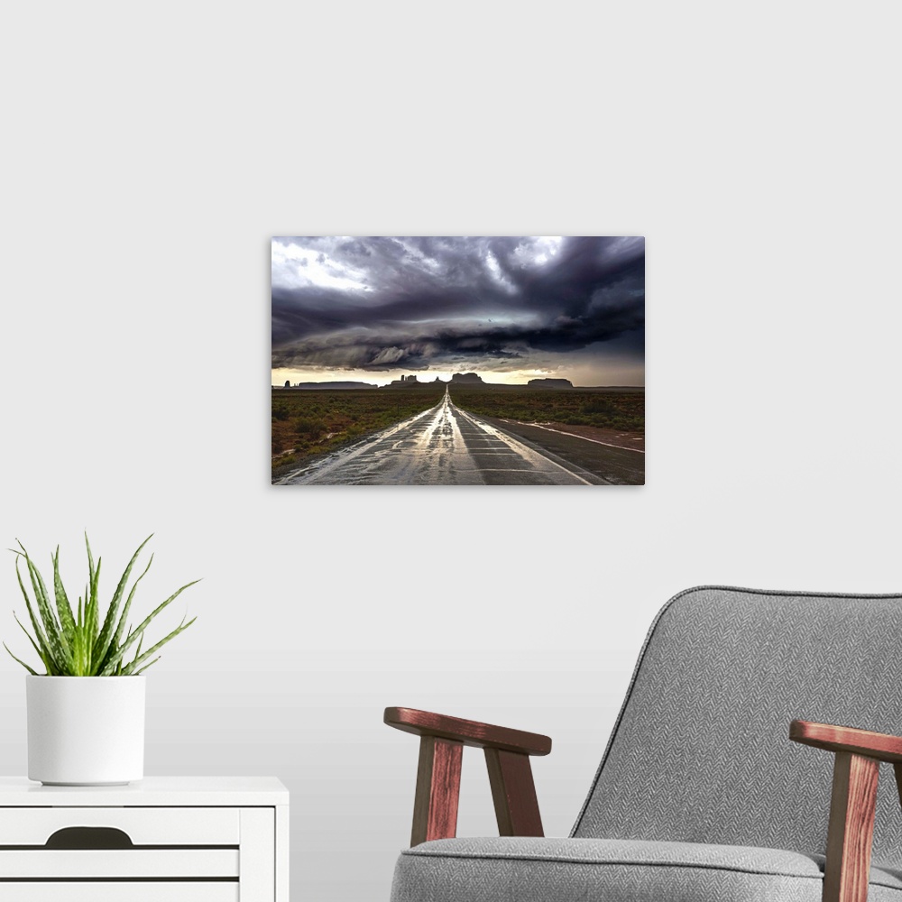 A modern room featuring Photograph of Monument Valley with dramatic clouds above taken from a wet road after a storm.