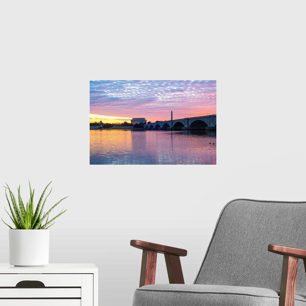 A modern room featuring The Lincoln Memorial and Washington Monument seen from the Potomac River with pastel-colored clou...