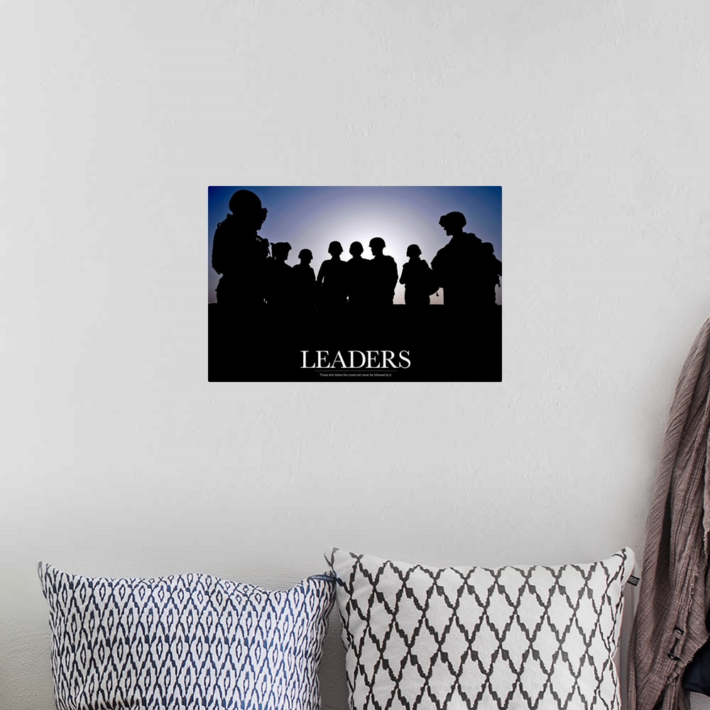 A bohemian room featuring Large photo of the silhouette of soldiers standing against a clear sky with text at the bottom.